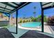 Comfortable outdoor patio by the pool for relaxation and entertaining with beautiful landscaping at 3266 Mountain Spring Rd, Las Vegas, NV 89146