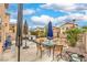 Backyard featuring a patio area, table and chairs, minimal landscaping, and exterior views at 3568 Gloucester Gate St, Las Vegas, NV 89122