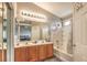 Main bath featuring double sinks, large mirror, tub/shower combo and bright lighting at 3568 Gloucester Gate St, Las Vegas, NV 89122