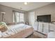 Cozy bedroom features a large window, neutral walls, TV and carpeted floors at 3568 Gloucester Gate St, Las Vegas, NV 89122