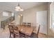 Dining area featuring a wood table with six chairs, tile flooring, and natural light at 3568 Gloucester Gate St, Las Vegas, NV 89122