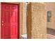 A close up of a vibrant red front door and textured stucco wall at 3568 Gloucester Gate St, Las Vegas, NV 89122