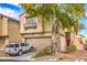 Two-story home with a tan exterior, a two-car garage, and minimal landscaping at 3568 Gloucester Gate St, Las Vegas, NV 89122