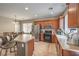 Well-lit kitchen with stainless steel appliances, tile floors, and kitchen island with barstool seating at 3568 Gloucester Gate St, Las Vegas, NV 89122