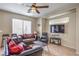 Inviting living room with tile floors, ceiling fan, comfortable seating, and natural light at 3568 Gloucester Gate St, Las Vegas, NV 89122