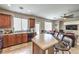 Spacious living room with kitchen including an island and bar stools and tile flooring at 3568 Gloucester Gate St, Las Vegas, NV 89122