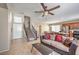 Spacious living room with tile flooring, staircase, and an open layout with the dining area and kitchen at 3568 Gloucester Gate St, Las Vegas, NV 89122