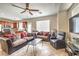 Open-concept living room and kitchen with tile floors and comfortable sofas at 3568 Gloucester Gate St, Las Vegas, NV 89122