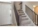 View of a carpeted staircase with wood railing leading to the upper level of the home at 3568 Gloucester Gate St, Las Vegas, NV 89122