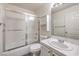 Standard bathroom features a tile sink, tub with shower, and frosted glass shower doors at 3660 Renovah St # 202, Las Vegas, NV 89129