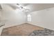 Bright bedroom features plush carpeting, ceiling fan, and a charming arched window at 3660 Renovah St # 202, Las Vegas, NV 89129