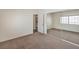 Bedroom featuring neutral carpet, mirrored closet, with access to kitchen and bedroom at 3660 Renovah St # 202, Las Vegas, NV 89129