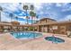 Sparkling community pool with hot tub, surrounded by palm trees and a lounging area at 3660 Renovah St # 202, Las Vegas, NV 89129