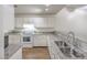 Cozy kitchen featuring updated appliances and granite countertops at 3660 Renovah St # 202, Las Vegas, NV 89129