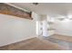 Open-concept living space with beamed accent, tiled flooring, and seamless kitchen access at 3660 Renovah St # 202, Las Vegas, NV 89129