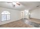 Inviting living room featuring neutral tones, tiled floors, and a bright arched window at 3660 Renovah St # 202, Las Vegas, NV 89129