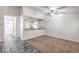 Well-lit living area with tiled entry, ceiling fan, and open bar-style counter to kitchen at 3660 Renovah St # 202, Las Vegas, NV 89129