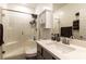 Bathroom features a glass-enclosed shower, gray vanity, and tile surround at 3817 Grazing Gazelle Ave, North Las Vegas, NV 89084