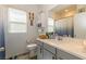 Well-lit bathroom featuring a toilet, vanity with gray cabinets, and decorative wall art at 3817 Grazing Gazelle Ave, North Las Vegas, NV 89084