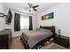 Relaxing bedroom featuring neutral carpet, mounted TV, fan, and closet with storage underneath the bed at 3817 Grazing Gazelle Ave, North Las Vegas, NV 89084