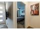 Bedroom featuring neutral carpet, mounted TV and fan, with closet and dresser and an accent painting at 3817 Grazing Gazelle Ave, North Las Vegas, NV 89084