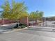 Gated community entrance with mature trees and landscaping offers security and curb appeal at 3817 Grazing Gazelle Ave, North Las Vegas, NV 89084