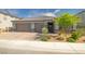 Charming single-story home featuring a three-car garage, desert landscaping, and a welcoming entrance at 3817 Grazing Gazelle Ave, North Las Vegas, NV 89084