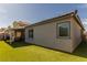 Exterior view of a home with an enclosed back patio and grassy yard at 3817 Grazing Gazelle Ave, North Las Vegas, NV 89084