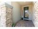 Inviting front entrance with stone pillars and a modern door with glass panels at 3817 Grazing Gazelle Ave, North Las Vegas, NV 89084