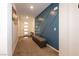 Entryway featuring carpet and a patterned accent wall with a storage bench at 3817 Grazing Gazelle Ave, North Las Vegas, NV 89084