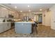 Bright eat-in kitchen with large island featuring bar stool seating, quartz countertops, and stainless appliances at 3817 Grazing Gazelle Ave, North Las Vegas, NV 89084