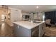 Gourmet kitchen with island overlooking the living and dining areas, plus a stainless steel dishwasher at 3817 Grazing Gazelle Ave, North Las Vegas, NV 89084