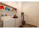 Convenient laundry room equipped with washer, dryer, and ample storage shelving above, and access to exterior at 3817 Grazing Gazelle Ave, North Las Vegas, NV 89084