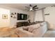Relaxing living room area with a large comfy sofa, ceiling fan, and built-in entertainment center at 3817 Grazing Gazelle Ave, North Las Vegas, NV 89084