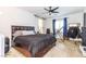 Main bedroom featuring a ceiling fan, sliding barn door to the ensuite bathroom, and lots of natural light at 3817 Grazing Gazelle Ave, North Las Vegas, NV 89084