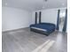 Spacious bedroom featuring modern gray floors, a blue duvet, two windows and recessed lighting at 3934 Palos Verdes St, Las Vegas, NV 89119
