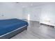 Bright bedroom featuring modern gray floors, a blue duvet, a crib and recessed lighting at 3934 Palos Verdes St, Las Vegas, NV 89119