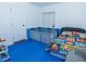 Playful ' room featuring colorful play mat, comfortable bed, and blue safety barrier at 3934 Palos Verdes St, Las Vegas, NV 89119