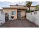 Home exterior with stucco walls, bricked patio, and secure gated entrance at 3934 Palos Verdes St, Las Vegas, NV 89119