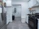 Modern kitchen with stainless steel appliances, white cabinets, and a seamless flow to the laundry area at 3934 Palos Verdes St, Las Vegas, NV 89119