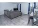 Bright living room with sleek gray flooring, modern furniture, and ample natural light at 3934 Palos Verdes St, Las Vegas, NV 89119