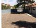View of empty backyard enclosed by a gray block wall and a gated entrance to the street at 3948 Applecrest St, Las Vegas, NV 89108