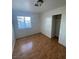 Bright bedroom with wood floors and a window view, featuring a closet with sliding doors at 3948 Applecrest St, Las Vegas, NV 89108