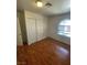 Bedroom with wood floors, standard closet, and arched window bringing in natural light at 3948 Applecrest St, Las Vegas, NV 89108