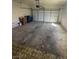 Two-car garage showcasing an electric door and ample space for parking and storage at 3948 Applecrest St, Las Vegas, NV 89108