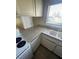 Kitchen features white cabinets and countertops and a double basin sink at 3948 Applecrest St, Las Vegas, NV 89108