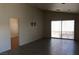 Bright living room with tile flooring, TV mount, and sliding glass doors to backyard at 3948 Applecrest St, Las Vegas, NV 89108