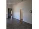Large living room with tile flooring, TV mount, and hallway access at 3948 Applecrest St, Las Vegas, NV 89108