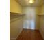 Spacious walk-in closet featuring wood floors and shelving for organized storage at 3948 Applecrest St, Las Vegas, NV 89108
