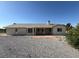 Expansive backyard with brick patio, desert landscaping, and a covered patio space at 4330 Turner Blvd, Pahrump, NV 89061
